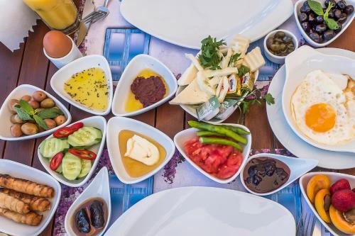 a table topped with bowls of different types of food at Villa Vongole in Çeşme