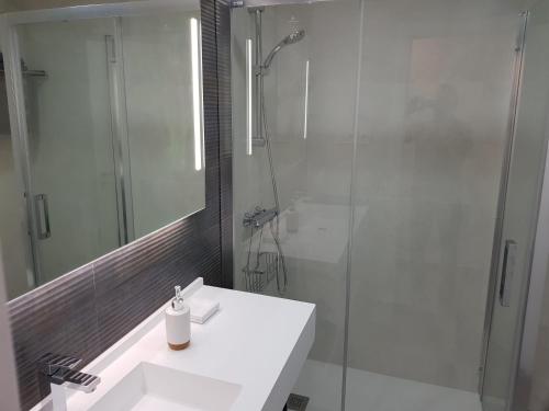 a bathroom with a white sink and a shower at CHINASOLYMAR LUXURY - Con Parking in Almuñécar
