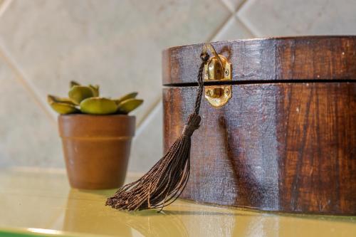 a wooden container sitting on a table next to a plant at House Garden Loft in Baricella