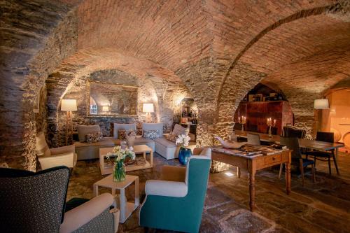 a large living room with a stone wall at Relais Montepepe Winery & Spa in Montignoso