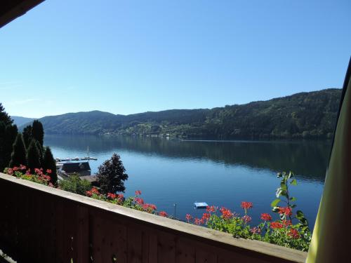 a view of a lake from a balcony at Pension Sedlak in Millstatt