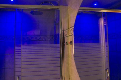 a staircase in a room with blue lights at Hotel Pella in Giannitsa