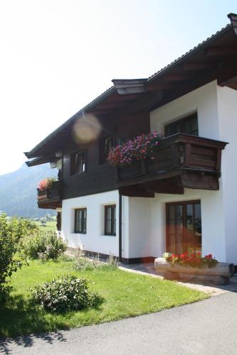 a house with flower boxes on the side of it at Auerschmied Appartements in Kirchdorf in Tirol