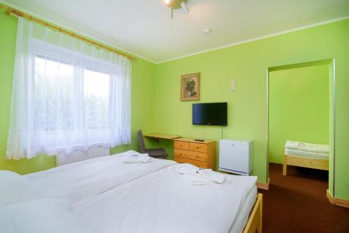 Postel nebo postele na pokoji v ubytování Hotel Max