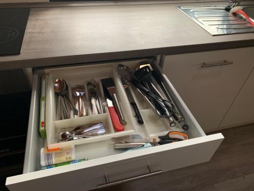 a drawer filled with utensils on a kitchen counter at Ferienhaus am Wäldchen in Uelsen