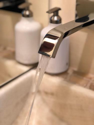 a faucet with water coming out of it at Magnolias Boutique Suites & SPA in San Cristóbal de Las Casas