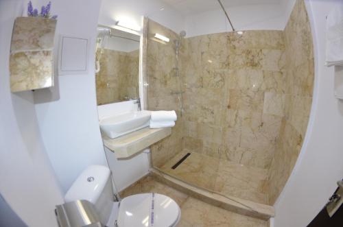a bathroom with a toilet and a sink and a shower at Hotel AquaMarine in Costinesti