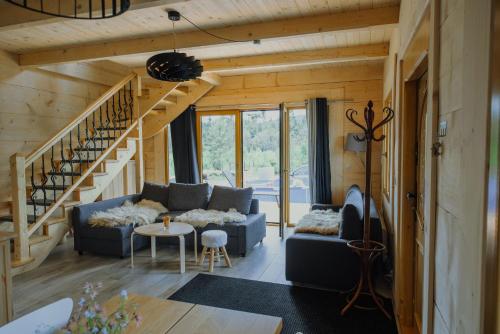a living room with a couch and a staircase at Polanka in Witów