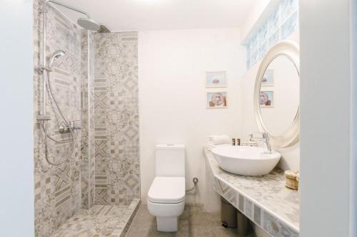 a bathroom with a toilet and a sink and a shower at Achinos guest house, Skopelos in Skopelos Town