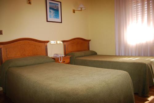 Ένα ή περισσότερα κρεβάτια σε δωμάτιο στο Hotel A Nieu