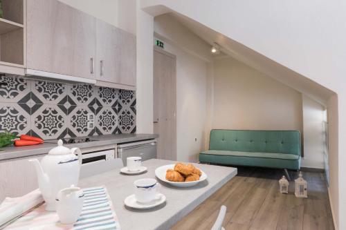 a kitchen with a table with a bowl of bread at Ipsos Beach Studios by Konnect in Ýpsos