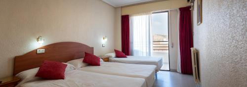 Postel nebo postele na pokoji v ubytování Hotel Quino