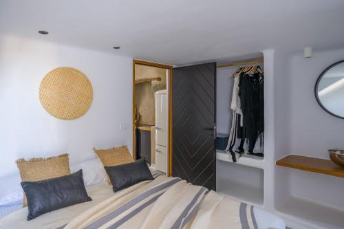 a bedroom with a bed and a closet at Euphoria Chora Naxos in Naxos Chora