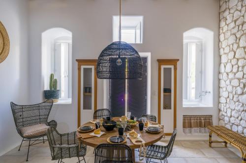 a dining room with a table and chairs at Euphoria Chora Naxos in Naxos Chora
