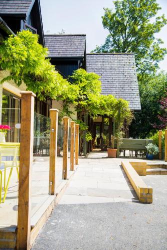 a walkway with trees in front of a building at Willowbeck Lodge Boutique Hotel in Carlisle