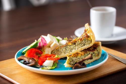 a plate of food with a sandwich and a salad at New Era Hotel Old Town Bucharest- parking with fee nearby - NOT at the hotel ! in Bucharest