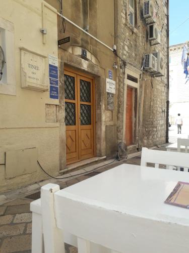 a white table in front of a building at Apartment Agora in Zadar