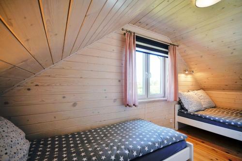 Cama ou camas em um quarto em Białe Domki Lux