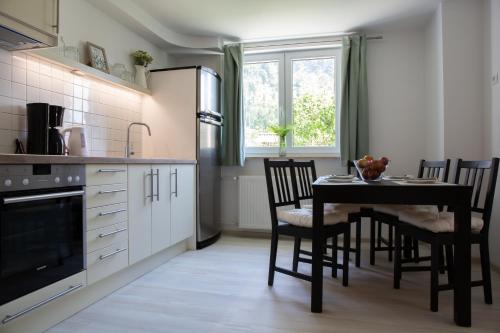 a kitchen with a table and chairs and a dining room at Apartments Korošec in Bled