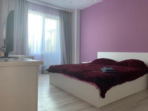 a purple bedroom with a bed and a sink at Французский Бульвар ЖК Париж in Odesa
