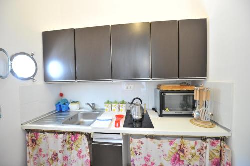 a kitchen counter with a sink and a microwave at Villa Walter in Sorrento