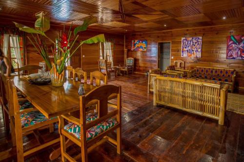 a dining room with a wooden table and chairs at Roça Saudade Guest House in Trindade