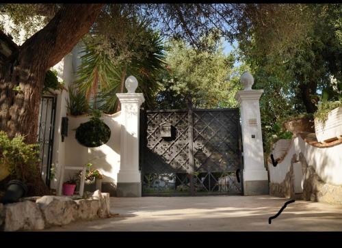 a white fence with a gate in front of a house at CASA SOFIA in Anacapri