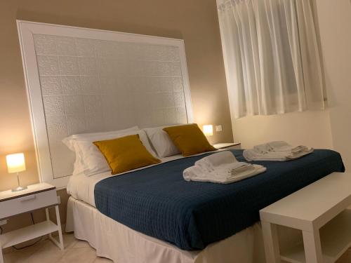 a bedroom with a bed with two towels on it at BeB L'ALLORO in Pachino