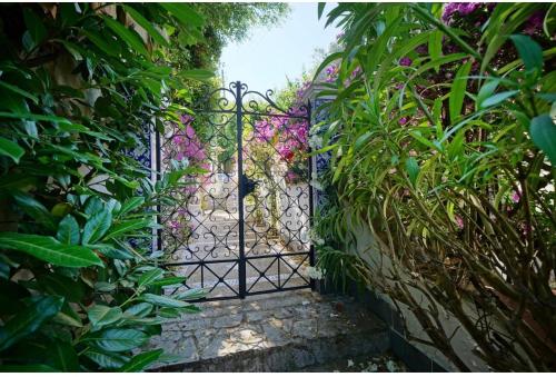 an entrance gate to a garden with flowers at CASA SOFIA in Anacapri