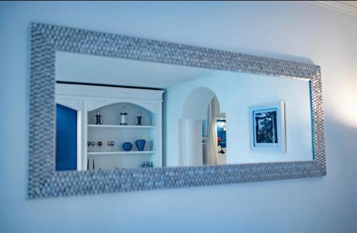 a mirror hanging on a wall in a room at CASA SOFIA in Anacapri
