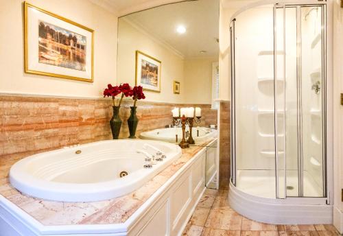 a bathroom with a large tub and a shower at Chiltern Inn in Bar Harbor