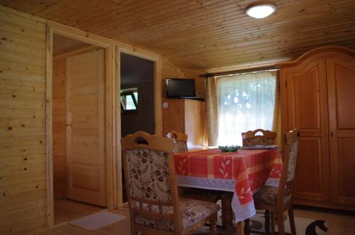 a dining room with a table and chairs and a window at Horváth Kert Vendégház in Zirc
