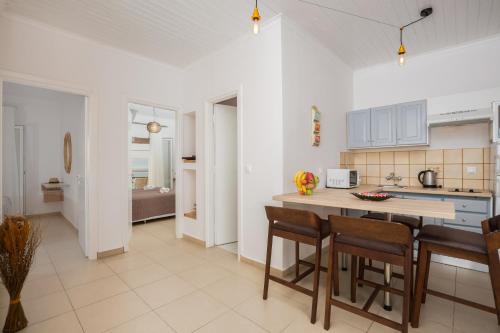 a kitchen and living room with a table and chairs at The Wave in Sidari