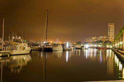 a group of boats docked in a harbor at night at Hotel Marítimo Urban in Alicante