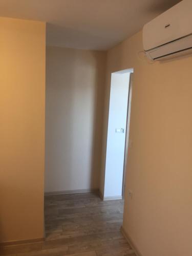 an empty room with a door and a hallway at Family Hotel Malibu in Chernomorets