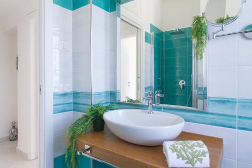 a bathroom with a sink and a mirror at AQUAMARINE Relaxing Capri Suites in Capri