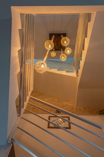 a staircase in a house with a chandelier at The Shipwright's Lodge in Marsaxlokk