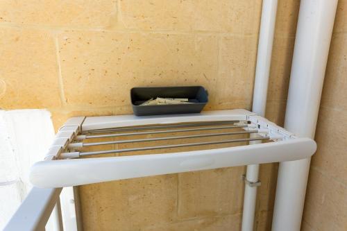 a shelf in a room with a box on it at The Shipwright's Lodge in Marsaxlokk