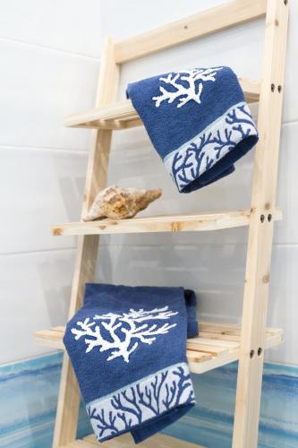 a wooden shelf with two blue and white towels at AQUAMARINE Relaxing Capri Suites in Capri