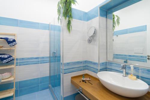 a bathroom with a sink and a glass shower at AQUAMARINE Relaxing Capri Suites in Capri