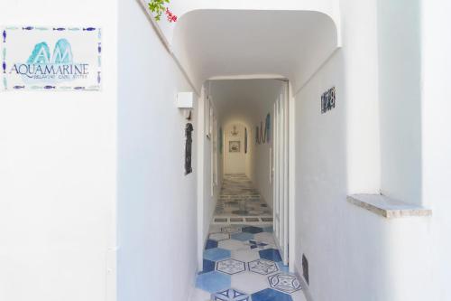 a hallway with blue and white tiles on the floor at AQUAMARINE Relaxing Capri Suites in Capri