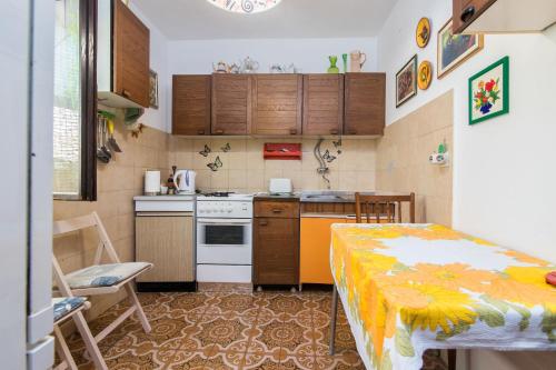 a small kitchen with a bed in a room at Apartment Sanka in Gdinj