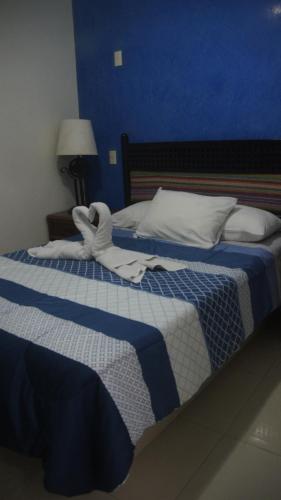 two beds in a bedroom with towels on them at Casa del Parque Vallarta in Puerto Vallarta