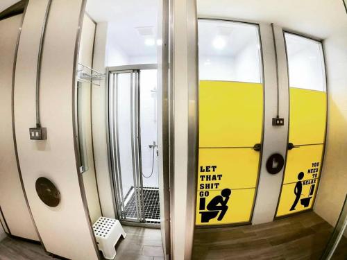 a bathroom with a mirror with a sign on it at 188 Station in Tainan