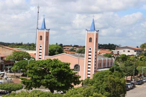 a church with two towers with blue spires at Flat com Varanda e Vista Mar in Paracuru