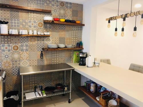 a kitchen with a counter and a counter top at Casa Bizu in Bacalar