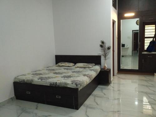 a bedroom with a bed in a room at Yaa Residency near VIT in Vellore