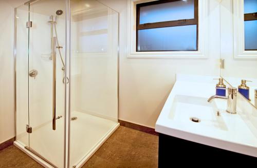 a bathroom with a sink and a shower at Pembroke Lodge in Wanaka