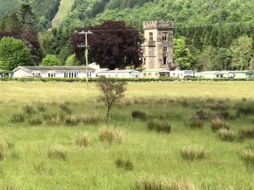 an old building in the middle of a field at Lyndhurst 39 in Dunoon