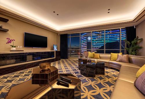 a living room with a couch and a television at The Darling at The Star Gold Coast in Gold Coast